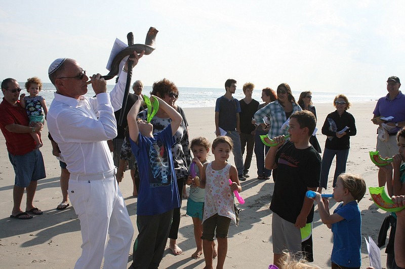 Provided/ Rabbi David M. Weis sounds the shofar at the Tashlich service on Huntington Ave. beach.