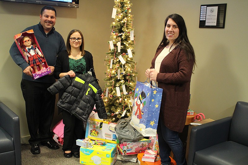 Pictured, from left, with some of the items are Associate Director Joe Lizza, facility coordinator Maria Gallo, and graduate student Taylor McKay who coordinated this year's drive.