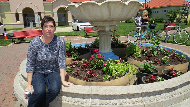 Sue Van Duyne shows the garden planted in the fountain behind the Ventnor Cultural Arts Center.