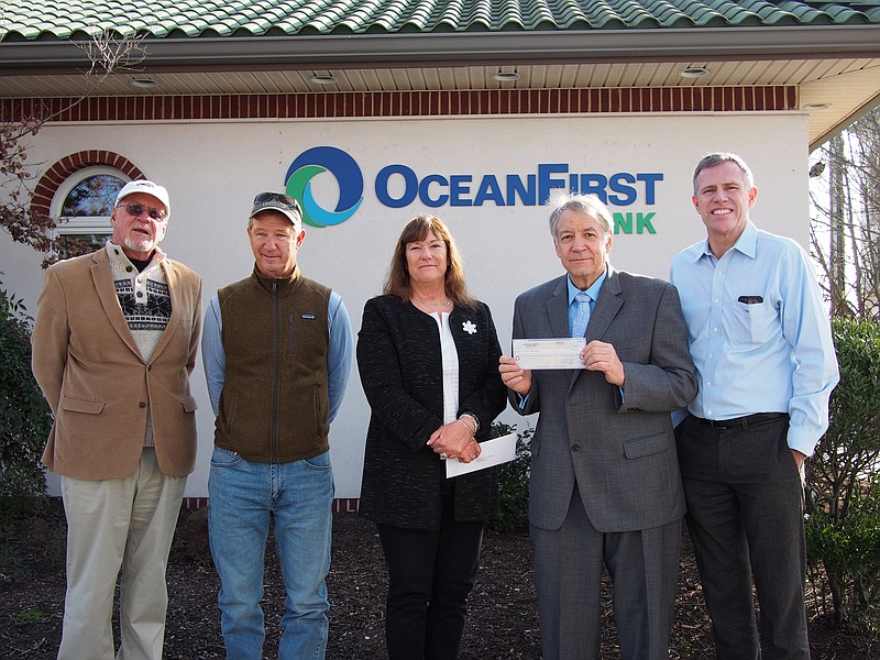 From left, Colleen Manera, OceanFirst Ventnor Branch Manager, center, presents a $5,000 check to New Jersey Coastal Coalition Board Members, from left, Bruce Funk of Longport, John Van Duyne of Ventnor, Executive Director Tom Quirk of Ventnor and Board Member Tom Heist of Ocean City Tuesday, Dec. 12 at OceanFirst Bank in Ventnor.