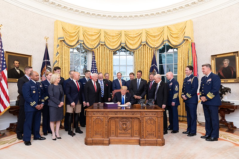 President Donald J. Trump signs S.140 The Frank LoBiondo Coast Guard Authorization Act of 2018 Tuesday, Dec. 4, 2018, in the Oval Office of the White House.  (Official White House Photo by Joyce N. Boghosian)