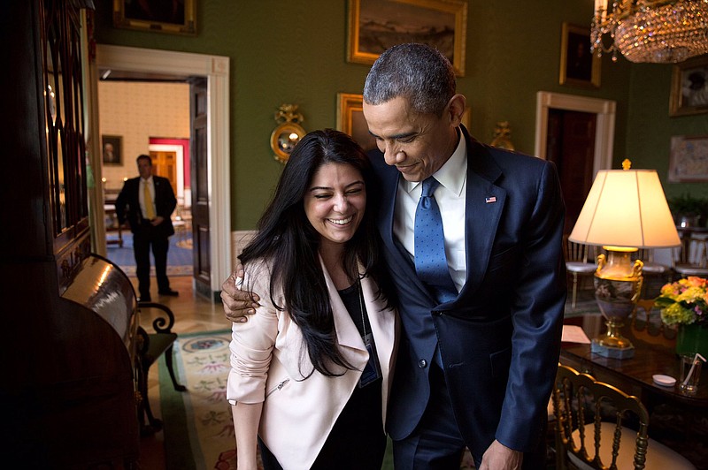 Obama Administration Archives/Ferial Govashiri with the President.