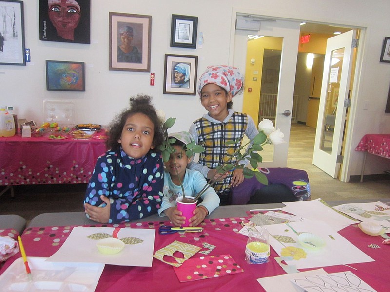 In the photo, Maniyah Kenneth, 7, Myalani Kenneth, 8, and Milani Kenneth, 9, enjoy making a craft for their mother.