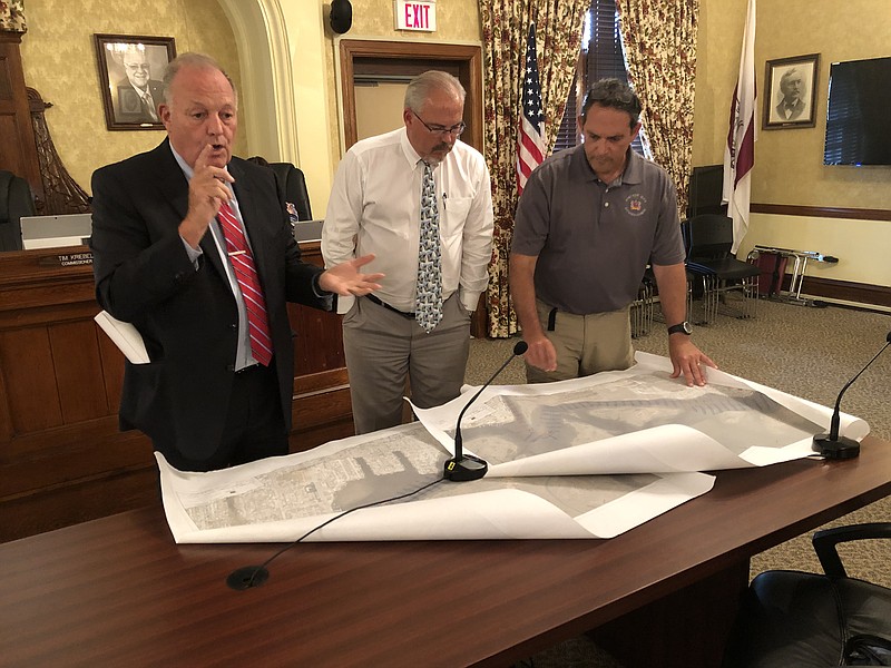 From left, Margate solicitor John Scott Abbott shows Ventnor Commissioners Lance Landgraf and Tim Kriebel maps of Shelter Island, which is co-owned by the two municipalities.