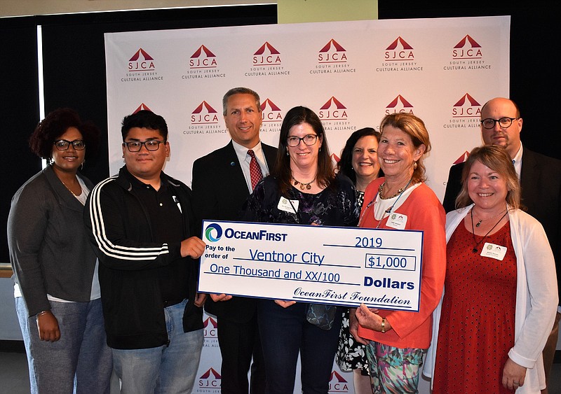 Ventnor City representatives, from left, Colin Fuentes, Sue Van Duyne-Hunter and Diane Birkbeck accept a $1,000 OceanFirst award for the ongoing mosaic project behind the Ventnor City Cultural Arts Center.