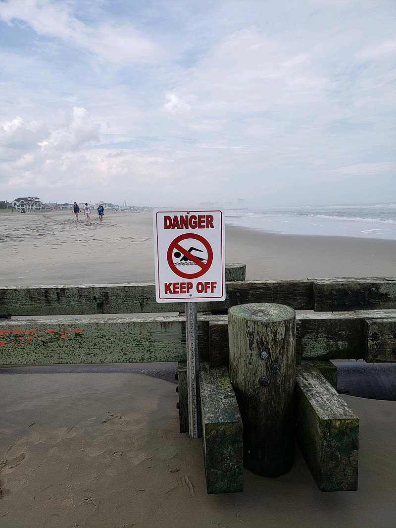 Signs warn beachgoers to keep off the outfall pipes.