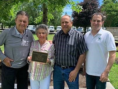 Photo Courtesy of AMSkier/From left,  Henry M. Skier, president of AMSkier, presented the Caring for Children Award to Carole Domsky, the wife of Marvin Domsky, their son Sam Domsky, and Andrew Yankowitz, director and owner of Tall Pines Day Camp.

 