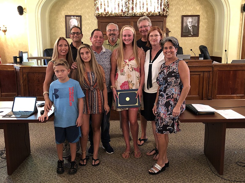 Ventnor Mayor Beth Holtzman, right, honored Lauren Merlino, left, and her friend Julia Logue, center, for their lifesaving actions. Also pictured, front, Marco Merlino, 11, Abra, Nick Merlino, and Logue;s parents, along with Commissioners Tim Kriebel and Lance Landgraf.