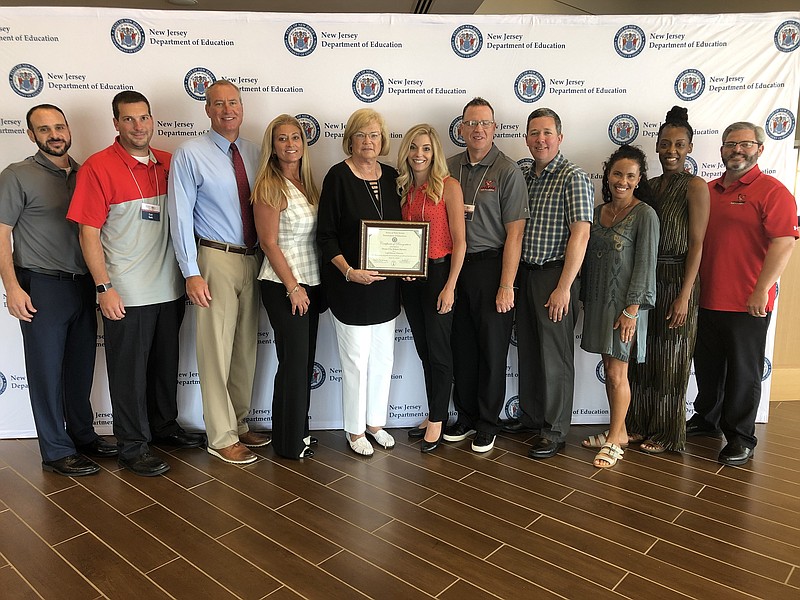 JASM Consulting/Ocean City school district administrators and staff accept the Lighthouse District designation at the N.J. Department of Education conference.