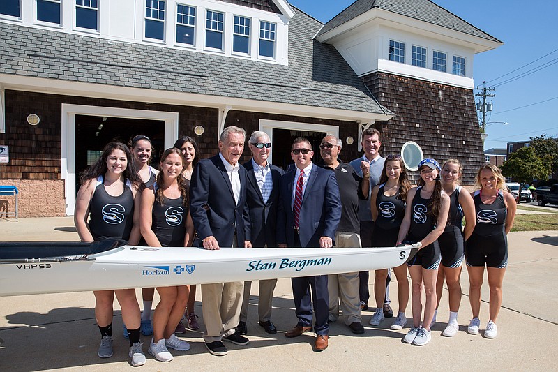 The Stockton Women's Eight Rowing team with, from left, William Gormley, Stan Bergman, Kevin Duffy, John Bancheri and Sean Gormley.