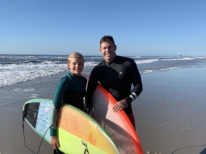 Michael Wright/ Sparkable/Brynn Gallagher,  11, of Ocean City, swept women's divisions and her father, Chad Gallagher, who won first place in the master's division, celebrate on the beach at the 19th annual Surf For A Cause Saturday, Sept. 7 in Margate.