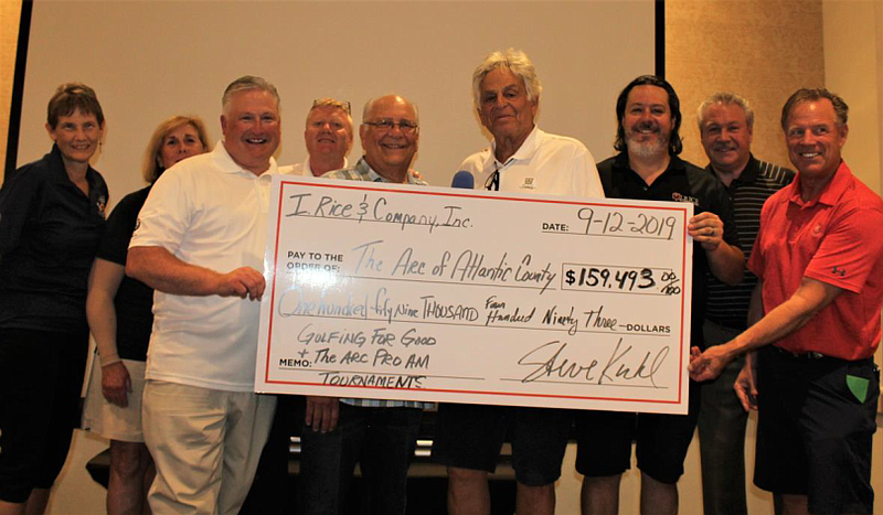 The Arc of Atlantic County CEO, Scott Hennis (third from left) is presented with a check by Steve Kuhl, President and Joe DiMedio, CEO, of I. Rice & Company, presents a $159,493 check, representing proceeds of the I. Rice Golfing for Good and The Arc of Atlantic County Pro-Am Golf Tournament held Sept. 12 at Seaview Golf Club. Also pictured are Philadelphia Flyers hockey legends Dave The Hammer Schultz and Brian Propp (far right) The Arc COO Pat Jones, CFO Jill Lemon,  and tournament Directors Irv Singer and Calum Kennedy (far left). 