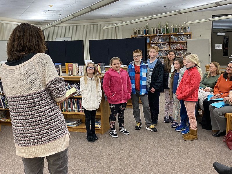 Teacher Jessica Cuevas recognizes students in the Ross School Garden Club for their work growing, harvesting and selling produce, the proceeds of which are used to feed the hungry.