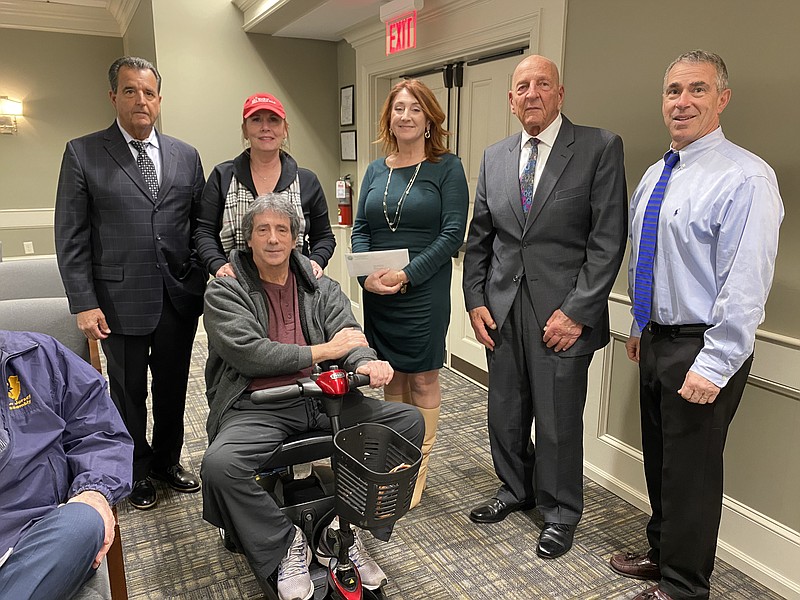 Margate CFO Lisa McLaughlin presents a check to Mark and Eileen Berardi for their advocacy for an experimental ALS treatment. Also pictured is Commissioner John Amodeo, Mayor Michael Becker and Commissioner Maury Blumberg.