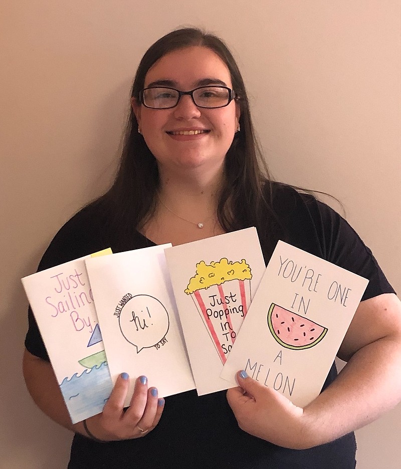 Provided/Ashley Berenato of Hammonton, vice president of the Stockton University Gerontology Club, with some of the cards members have made.