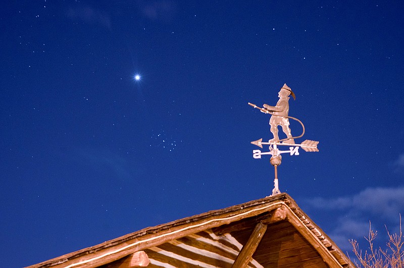 Steve Jasiecki/On April 7, the fireman on the Margate Log Cabin weather vane points to the planet Venus, while the wind directional arrow points to the Pleiades.  