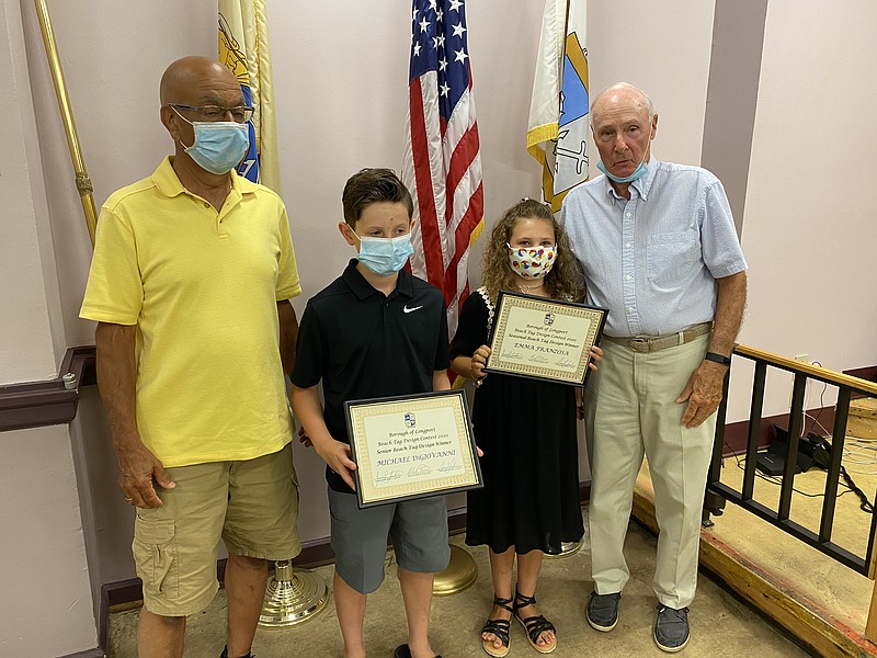 From left, Mayor Nicholas Russo, beach tag winners Michael DiGiovanni, Emma Franzosa and Commissioner Jim Leeds.