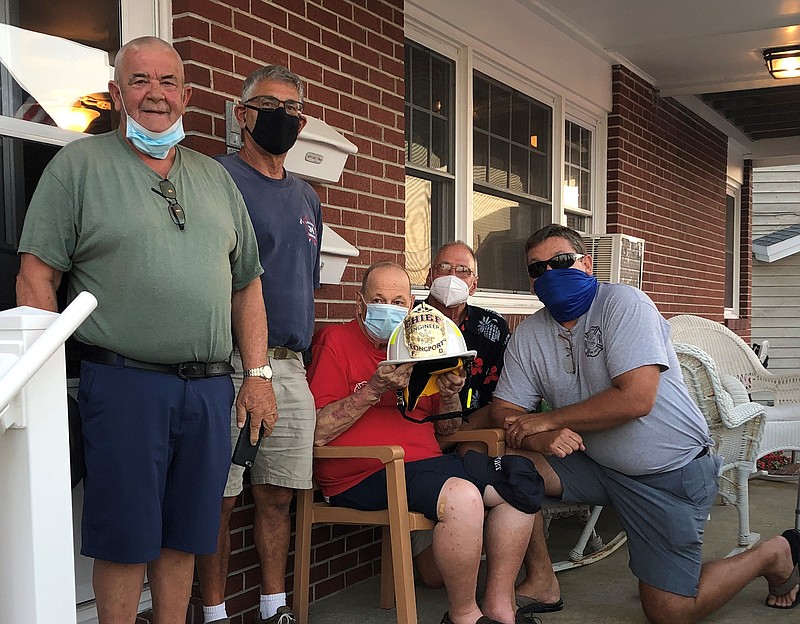 Longport Volunteer Fire Chief Levon "Lefty" Clayton, second from left, and members of the fire department presented Bill Fiore with a new helmet and an honorary title, Chief Engineer Emeritus.