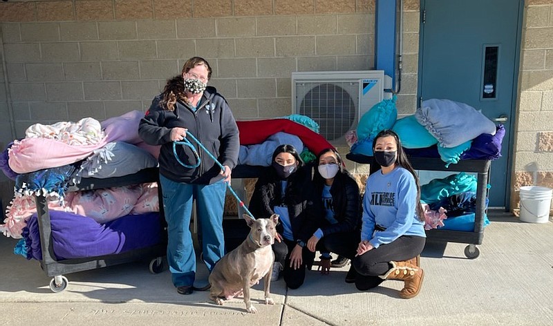 STOCKTON/From left, shelter volunteer coordinator Jennifer Pagliarini with Honey,  Stockton student volunteers Farihah Jahan and Divya Rajput, and MLK Day co-coordinator Paige Richards. 