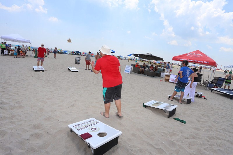 Cornhole has become a popular sport at the shore, here players toss the bag at Beachstock 2024 in Margate.