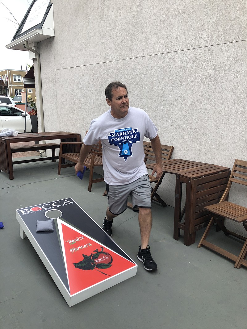 Lou Freedman of Bocca takes his turn at the cornhole tournament.