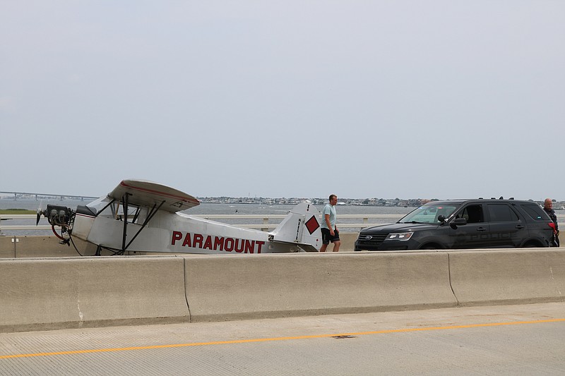 Landon Lucas, 18, flying for Paramount Air Service, landed his plane on the 9th St. Bridge after experiencing engine trouble.