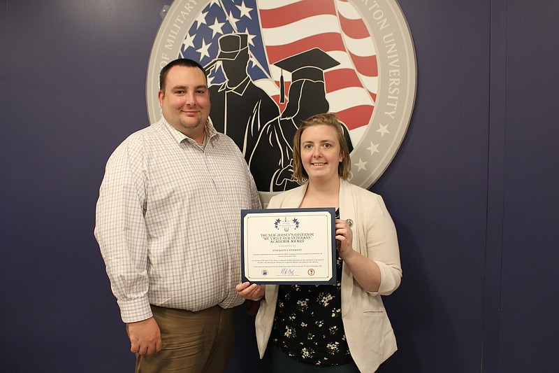 Michael Barany, Director of the Stockton Military and Veteran Success Center and assistant director Ashley Jones with the  We Value Our Veterans New Jersey Governor's Academia Award certificate.  (Photo by Diane D'Amico, Stockton University)