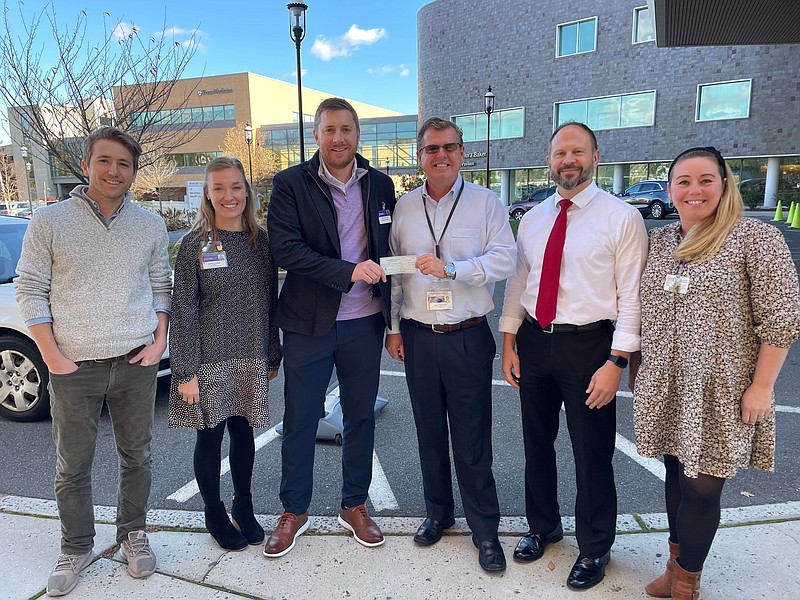 David Beyel, Jr. presents a $20,000 donation to Shore Medical Center Chief Development Officer and Chief Financial Officer David Hughes, representing proceeds from the 2021 Kyle Evans Memorial Golf Outing. Pictured from left, Nick Canderan, Shore Pharmacist Shannon Burke, Beyel, Hughes, Shore Director of Pharmacy Matt Piskun, and Shore Development Manager Jessica Giles.