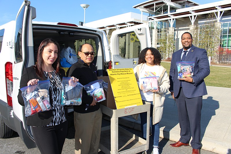 Stockton/From left, Calli Votta, Toma Itaas, Damaris Kauffman and Brett Pulliam load packages to deliver to the Atlantic City Rescue Mission. 
