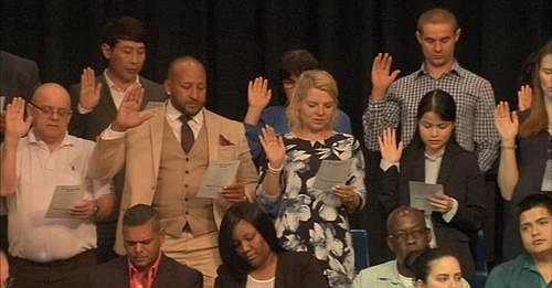 Immigrants take the Oath of Allegiance during a Naturalization Ceremony held at the Egg Harbor City Community School May 2, 2019.