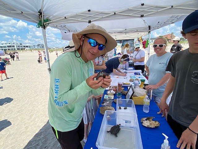 Steve Jasiecki, chairman of Sustainable Margate, holds a baby terrapin in the environmental science tent at Beachstock.