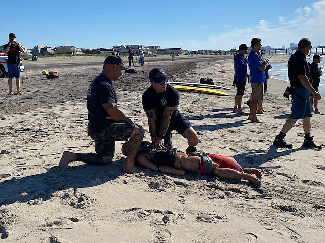 Margate Beach Patrol members perform CPR on a training dummy.