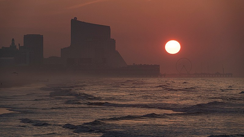 STEVE JASIECKI/Thick haze obscures the sun as it rises over Atlantic City indicating another scorcher of a day. 