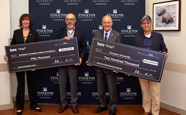 From left, Donna Buzby, chair of the Stockton University Foundation; Steven Silverstein, CEO of Spencer's and Spirit Halloween; Harvey Kesselman, president of Stockton; and Isaac Silvera, president and COO of Spencer's and Spirit Halloween.