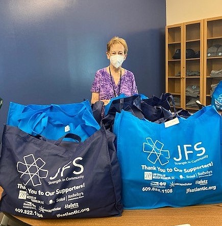 Provided/Jewish Family Service staff member Linda Kaplan labels non-perishable food bags which will be delivered to community residents. The JFS Pantry provides an array of products to individuals and families in need. With the ACME Markets Foundation $30,000 Nourishing Neighbors grant, JFS is able to keep pantry shelves stocked with hearty and healthy foods. 