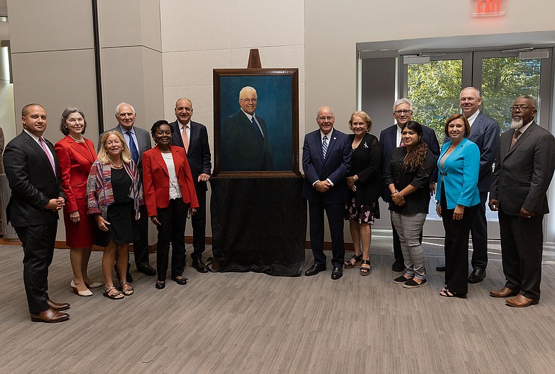 Members of the Board of Trustees celebrate President Harvey Kesselman after unveiling his presidential portrait Wednesday. From left, Jose Lozano, Michelle Lenzmeier Keates, Nancy Davis, Andy Dolce, Sonia Gonsalves, Ray Ciccone, Kesselman, Meg Worthington, Leo Schoffer, Liliana Morales, Nelida Valentin, Stanley Ellis and the Rev. Collins Days Sr.