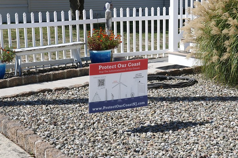 Some Ocean City homeowners display anti-wind farm signs on their lawns.
