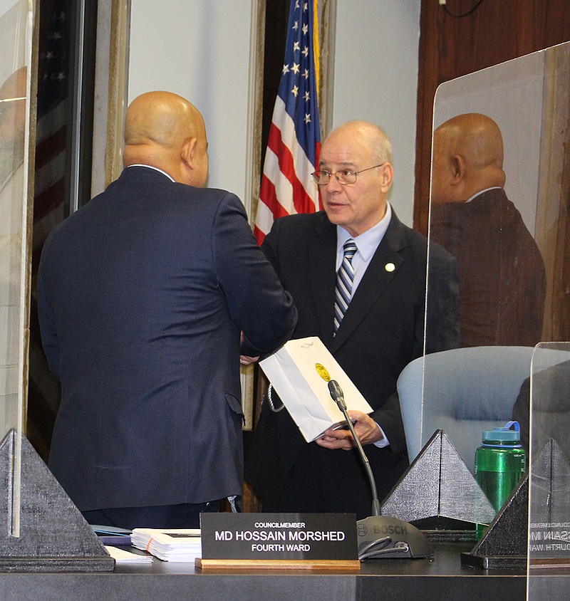 Provided/Stockton University President Harvey Kesselman presents Atlantic City Councilman MD Hossain Morshed with a commemorative Stockton coin at the Dec. 21 City Council meeting in Atlantic City. Kesselman presented each council member with a coin.