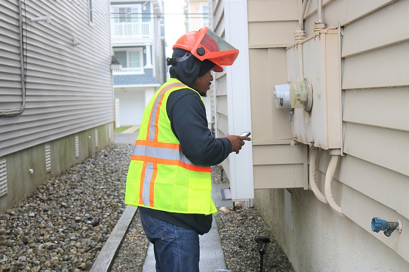 Atlantic City Electric technician Sam Miller installs a smart meter at an Ocean City residence.