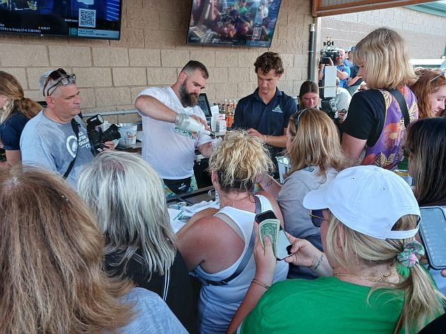 Jason Kelce mixes drinks for his fans during his celebrity bartender appearance.