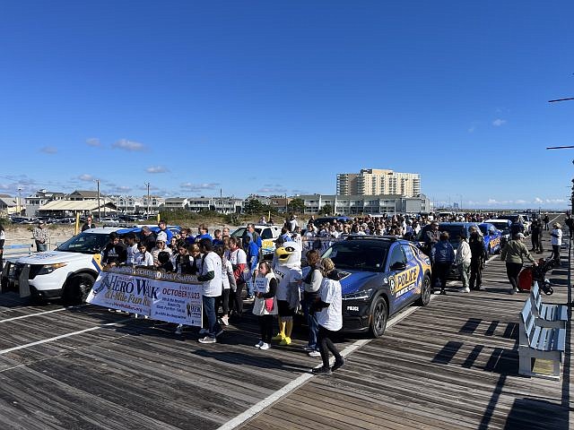 Hundreds of participants gather behind a HERO Campaign banner at the start of the fundraising walk. (Photos by Brooke Feldman)