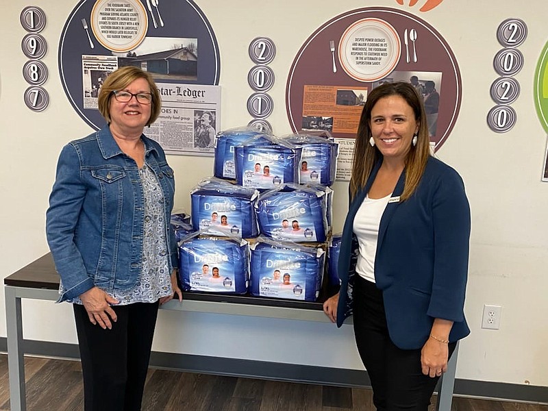 PROVIDED/Community FoodBank of NJ Advisory Board member April Venable, right, of Salem, presents a diaper donation to Kathy Corbalis, chair of Women Fighting Hunger. 