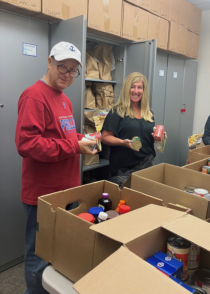 Provided/Burt Rose and Barbara Cohen sort High Holiday donations from Beth El Synagogue, Congregation Beth Israel, Shirat Hayam, Temple Beth Shalom and community residents. More than 200 bags of non-perishable food was collected to stock the pantry shelves at Jewish Family Service of Atlantic & Cape May Counties. 