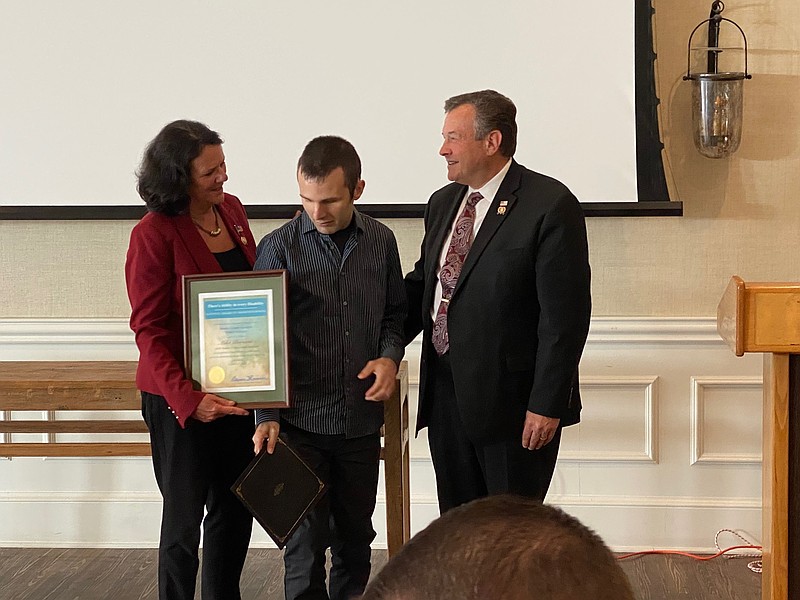 Atlantic County Commissioners Maureen Kern and John Risley present previous Donald J. Sykes Award winner Mike Bersani.