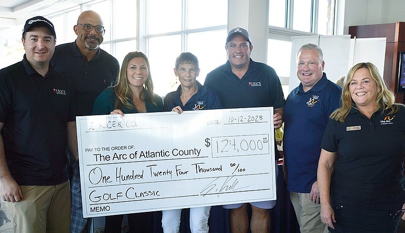 PROVIDED/Standing with the big check representing $124,000 in proceeds are, from left, Greg Stagnitta, I. Rice & Company; Darren Clinkscale, Board Chair; Ashley Simons, CFO; Pat Jones, COO; Dominic Gallo, I. Rice & Company; Scott Hennis, CEO; and Mary Ruley Moyer, Director of Development and Community Outreach.