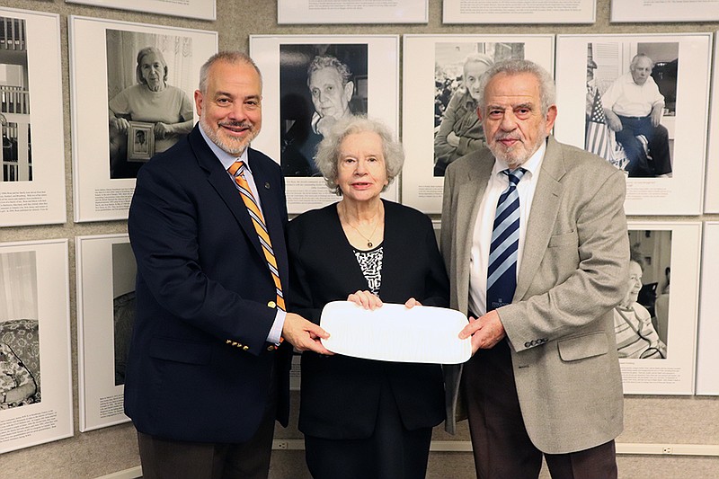 Provided/From left, Stockton President Joe Bertolino presents a ceramic plate from Mudgirls Studios in Atlantic City to Monique Richardson and Daniel Kochavi. Monique and Daniel donated money to the Stockton Foundation to establish the Judith and Israel Kochavi Memorial Endowed Scholarship Fund.