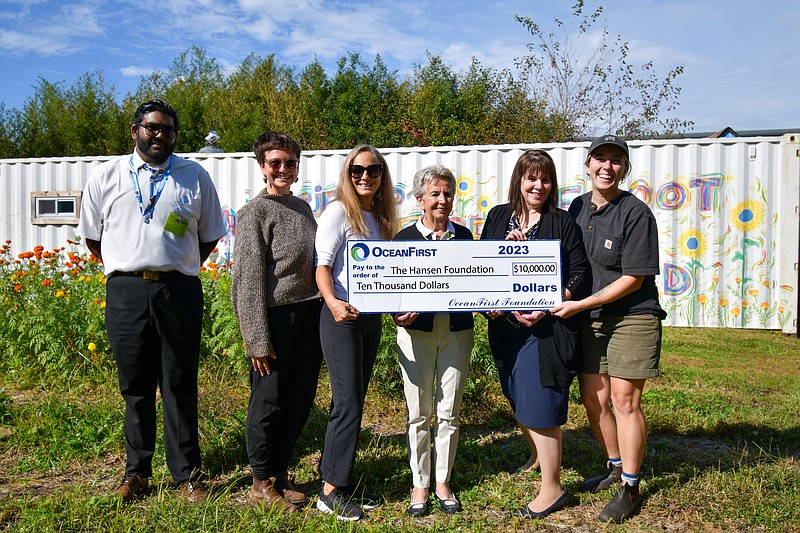 Michael Jaggernauth (far left) and Linda Calderon (second from right) of OceanFirst Bank present the $10,000 grant to (l. to r.) Enlightened Farm Director Brianna Bee, Hansen Foundation President Jennifer Hansen, Hansen Foundation Vice President Edwina Hansen and Megan Reid of Enlightened Farm