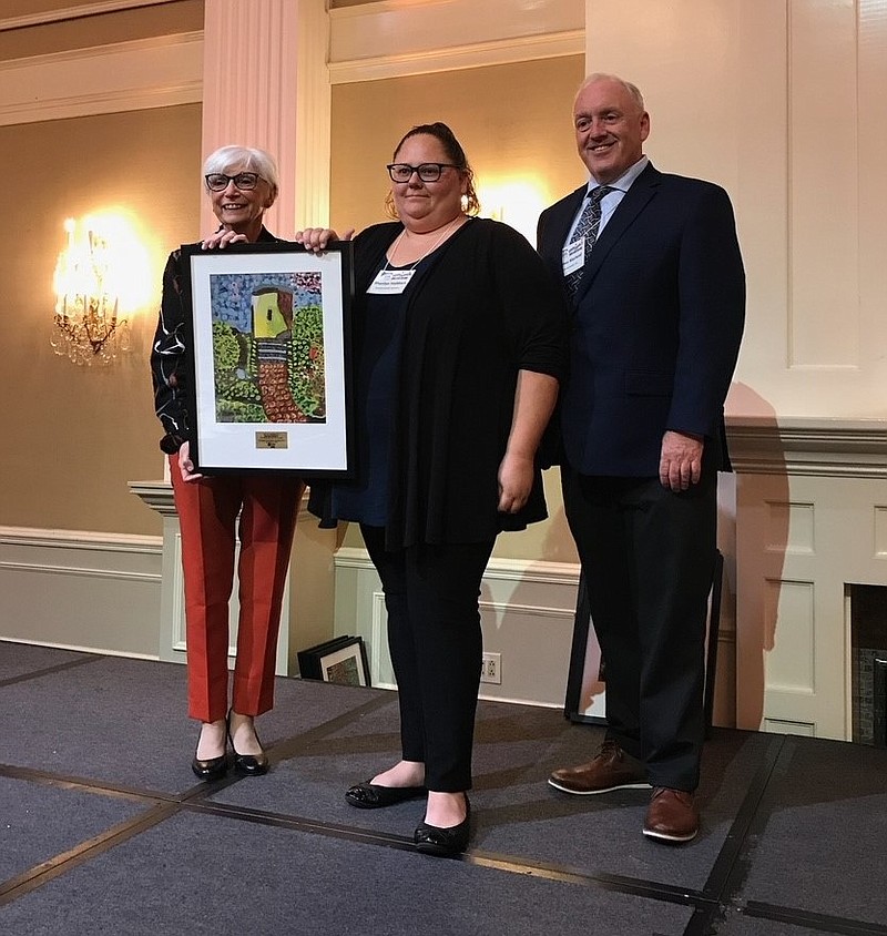 Provided/Sherilyn Haddock receives the Supportive Housing Hero Award of the Year award from Supportive Housing Association Executive Director Diane Riley and SHA Trustee James Marhold.