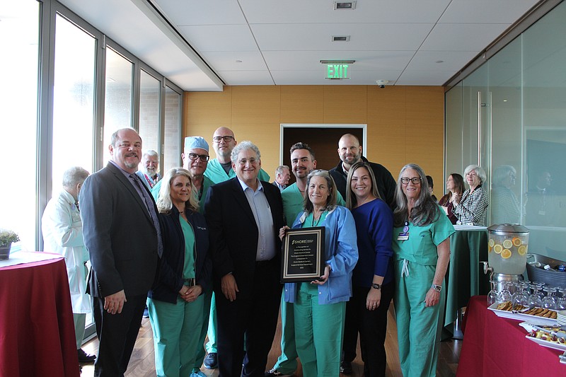 Provided/Dr. Leonard Galler, center, presented the Surgical Services Department at Shore with the 16th annual Surgical Chairman's Award for their team's commitment to excellence. Karen Burns, RN, BSN, CNOR, Manager, Operating Room & Sterile Processing Department, accepted the award on behalf of the department. 