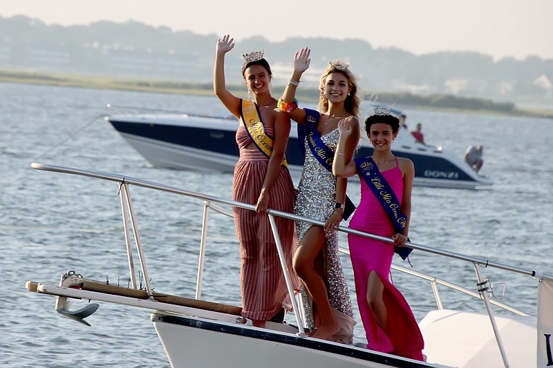 Miss Ocean City 2022 Maddyn Randazzo, left, Junior Miss Makenna Fleming and Little Miss Arianna DiAntonio give a wave during the Night in Venice Boat Parade. (Photo courtesy of Ocean City)